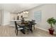 Dining room with an open layout to kitchen and an outside view through a large window at 5998 Amberly Dr, Bradenton, FL 34208