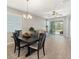 Dining room with a chandelier, a large window, and wood-look tile flooring at 5998 Amberly Dr, Bradenton, FL 34208