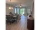 Open concept dining room features wood floors, views to the living room, and views to the backyard at 5998 Amberly Dr, Bradenton, FL 34208