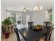 Dining room flowing into the living area with access to an outdoor patio through sliding glass doors at 5998 Amberly Dr, Bradenton, FL 34208