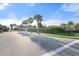 Amberly community entrance showcasing the landscaping and gate with palm trees at 5998 Amberly Dr, Bradenton, FL 34208