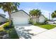 Charming single-Gathering home with a three-car garage, well-manicured lawn, and lush palm trees at 5998 Amberly Dr, Bradenton, FL 34208