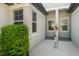 Inviting front porch featuring neutral colors, clean lines, and lush greenery, creating a welcoming entrance at 5998 Amberly Dr, Bradenton, FL 34208