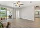 Bright living room with tile floors and sliding glass doors leading to a patio at 5998 Amberly Dr, Bradenton, FL 34208
