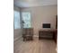 Bright office area features a neutral color palette, chair, wood desk and large windows at 5998 Amberly Dr, Bradenton, FL 34208