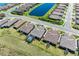 An aerial view shows single-Gathering homes with backyard pools, surrounded by lush greenery and lakes in a gated community at 6179 Mesa Gln, Bradenton, FL 34203