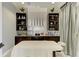 Inviting spa room with massage table, sink, mini fridge and serene decor at 6179 Mesa Gln, Bradenton, FL 34203