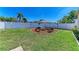 Backyard with a fire pit, seating and green grass at 6415 Fetterbush Ln, Lakewood Ranch, FL 34202