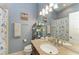 Bathroom features blue walls, granite countertop and nautical themed shower curtain at 6415 Fetterbush Ln, Lakewood Ranch, FL 34202