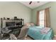 Bedroom with desk, monitors, and a window with curtains at 6415 Fetterbush Ln, Lakewood Ranch, FL 34202