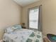 Cozy bedroom with a comfortable bed, window and bedside table at 6415 Fetterbush Ln, Lakewood Ranch, FL 34202