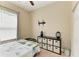 Bedroom with neutral colors, a side table and a TV bracket on the wall at 6415 Fetterbush Ln, Lakewood Ranch, FL 34202