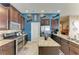 Kitchen with stainless steel oven, stove and appliances, beautiful granite countertops, tile floors, and blue walls at 6415 Fetterbush Ln, Lakewood Ranch, FL 34202