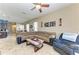 Inviting living room featuring a large sectional sofa, tile flooring, and an open layout at 6415 Fetterbush Ln, Lakewood Ranch, FL 34202