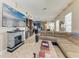 Bright living room boasts tile floors, stone fireplace, and a large screen television above the mantel at 6415 Fetterbush Ln, Lakewood Ranch, FL 34202