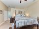Main bedroom with four-poster bed, ensuite bathroom, and neutral-toned walls at 6415 Fetterbush Ln, Lakewood Ranch, FL 34202