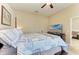 Cozy bedroom with four poster bed, sitting area, and mounted television at 6415 Fetterbush Ln, Lakewood Ranch, FL 34202
