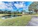 Scenic pond view near community center, surrounded by lush greenery and beautiful landscaping at 6415 Fetterbush Ln, Lakewood Ranch, FL 34202