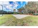 Sandy volleyball court with net set up, surrounded by trees and green space at 6415 Fetterbush Ln, Lakewood Ranch, FL 34202