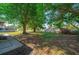 Lush backyard featuring mature trees providing ample shade and a storage shed at 6639 Electra Ave, North Port, FL 34287