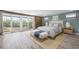 Cozy bedroom showcasing soft blues and wood accents, complemented by natural light and sliding doors to outdoors at 6814 68Th E Ave, Bradenton, FL 34203