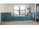 Entryway with custom built-in teal colored storage cabinets and bench seating at 6814 68Th E Ave, Bradenton, FL 34203