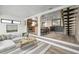 Open-concept living area seamlessly connects the kitchen, dining, and living spaces with unique stairs and hardwood floors at 6814 68Th E Ave, Bradenton, FL 34203