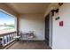 Cozy outdoor seating on the balcony offers a relaxing space with a small table and chairs at 7151 Wood Creek Dr # 205, Sarasota, FL 34231