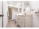 Well-lit bathroom boasts double sinks, neutral color palette, updated fixtures, and a convenient walk-in shower at 7151 Wood Creek Dr # 205, Sarasota, FL 34231