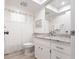 Clean bathroom with granite countertops, white cabinets, and a shower featuring white tiling with modern fixtures at 7151 Wood Creek Dr # 205, Sarasota, FL 34231