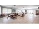 Spacious community room featuring a library, sofa, and a table with chairs at 7151 Wood Creek Dr # 205, Sarasota, FL 34231
