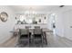 Modern dining area with tile floors and view to the kitchen at 7151 Wood Creek Dr # 205, Sarasota, FL 34231