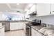Bright kitchen with granite countertops and stainless steel appliances at 7151 Wood Creek Dr # 205, Sarasota, FL 34231