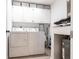 Efficient laundry room with a washer, dryer, storage cabinets, and a water heater providing functionality and organization at 7151 Wood Creek Dr # 205, Sarasota, FL 34231