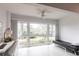 Bright living room with a large window offering beautiful backyard views and a modern ceiling fan at 7151 Wood Creek Dr # 205, Sarasota, FL 34231