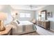 Serene bedroom showcases a tufted headboard, elegant furnishings, and soft, natural light creating a relaxing retreat at 7151 Wood Creek Dr # 205, Sarasota, FL 34231
