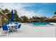 Spend time relaxing by the community pool that features lounge chairs and tables with umbrellas at 7151 Wood Creek Dr # 205, Sarasota, FL 34231
