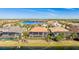 Aerial view of a luxurious home with pool near a pond and green space at 7211 Prestbury Cir, Lakewood Ranch, FL 34202