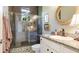 Well-lit bathroom featuring a glass shower with a brushed chrome showerhead and granite countertops at 7211 Prestbury Cir, Lakewood Ranch, FL 34202
