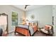 Bedroom with neutral paint, updated floors, and a large bright window at 7211 Prestbury Cir, Lakewood Ranch, FL 34202