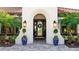 Elegant home entrance featuring manicured landscaping, blue decorative urns and a tiled walkway at 7211 Prestbury Cir, Lakewood Ranch, FL 34202
