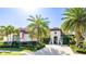 Stunning single-story home with a tile roof, lush landscaping, and a beautiful brick driveway at 7211 Prestbury Cir, Lakewood Ranch, FL 34202