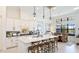 Beautiful kitchen with white cabinets, marble countertop island and pendant lighting at 7211 Prestbury Cir, Lakewood Ranch, FL 34202