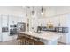 Modern kitchen with white cabinets, stainless steel appliances, and a large center island at 7211 Prestbury Cir, Lakewood Ranch, FL 34202
