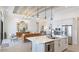 Open-concept kitchen with marble countertops, large island and adjoining living space at 7211 Prestbury Cir, Lakewood Ranch, FL 34202