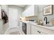 Bright laundry room with modern washer and dryer, ample counter space, and built-in cabinets at 7211 Prestbury Cir, Lakewood Ranch, FL 34202