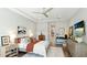 Bright main bedroom features wood floors, ceiling fan, tray ceiling and neutral paint at 7211 Prestbury Cir, Lakewood Ranch, FL 34202