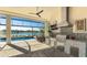 Outdoor kitchen with stainless steel grill, granite countertops, and view of the pool and lake at 7211 Prestbury Cir, Lakewood Ranch, FL 34202