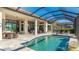 Covered patio and pool with waterfall features at 7211 Prestbury Cir, Lakewood Ranch, FL 34202