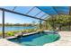 Screened pool with lake view and tropical landscaping at 7211 Prestbury Cir, Lakewood Ranch, FL 34202